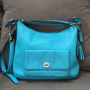 Coach turquoise handbag with shoulder strap.